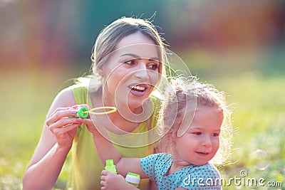 Happy Childhood â€“ Family blows soup foam and make bubbles Stock Photo